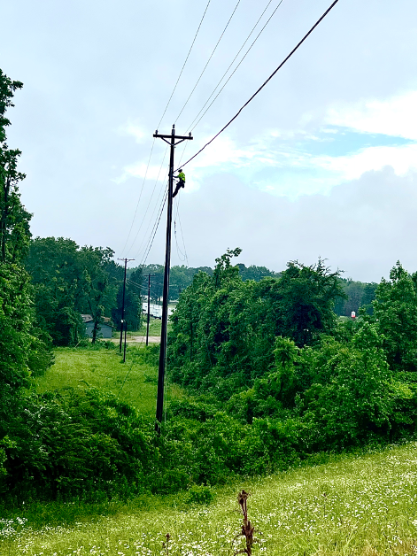 National OnDemand aerial lineman works on pole in rural America to help install broadband in rural communities.