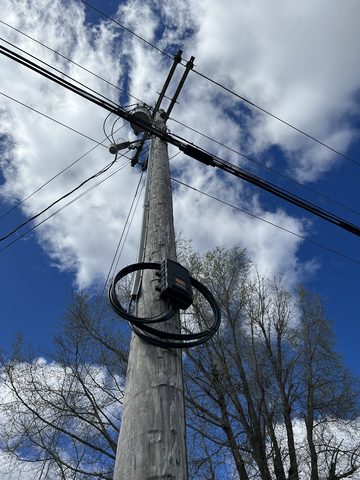 Fiber cable hangs from a pole just before a customer gets a broadband connection in Oxford, Miss. Conquer Digital Divide