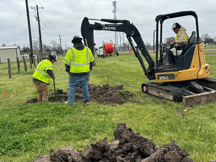 A National Ondemand crew works on burying a telecommunications vault in east Texas.