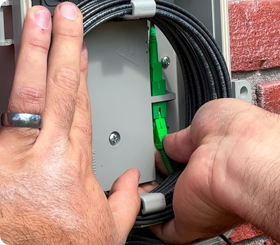 Precision and care in action—our telecommunications technician  expertly connects high-speed fiber optic cables to ensure seamless communication and connectivity for homes and businesses.